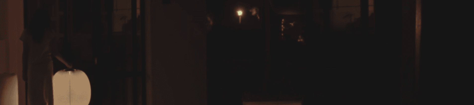 A softly glowing lamp in a dark interior