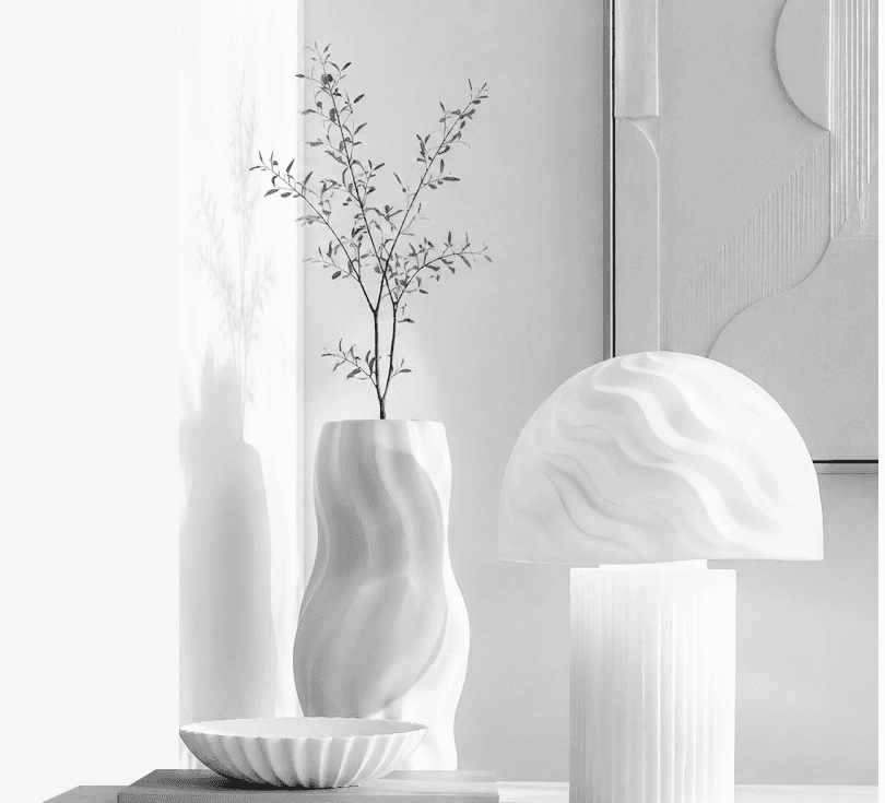 A monochrome EDITION8 lamp, vase and decorative bowl