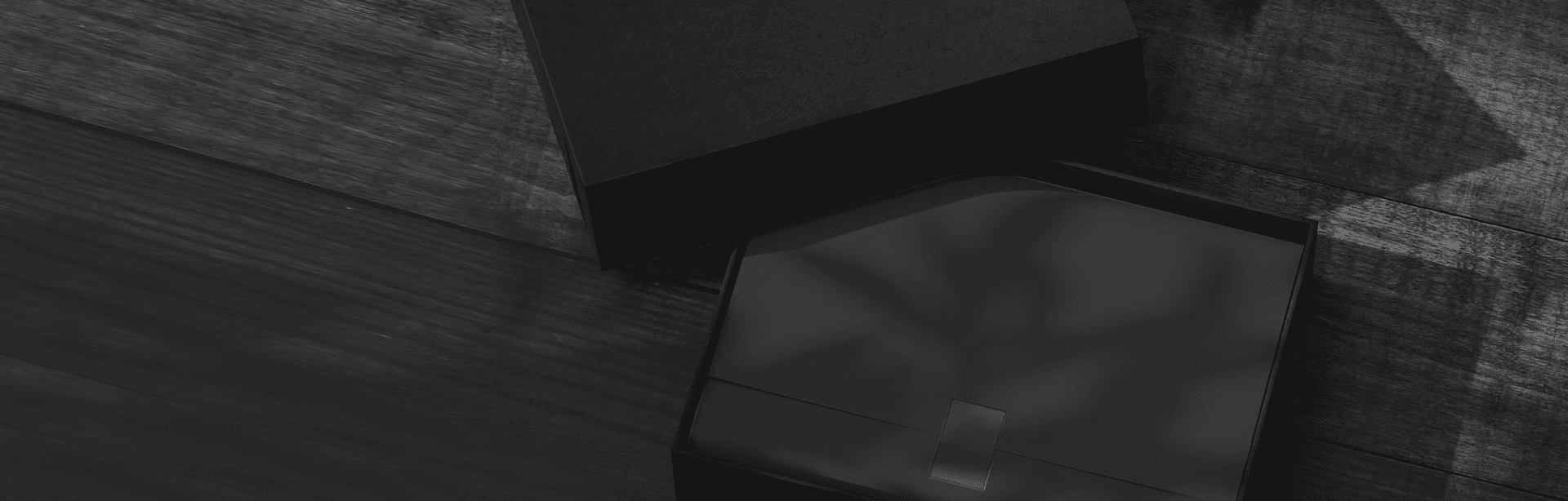 A refined black gift box in a dark setting