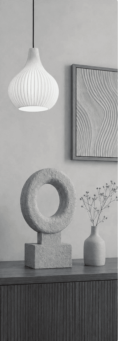 A monochrome EDITION8 interior with a pendant light and sculptural decor